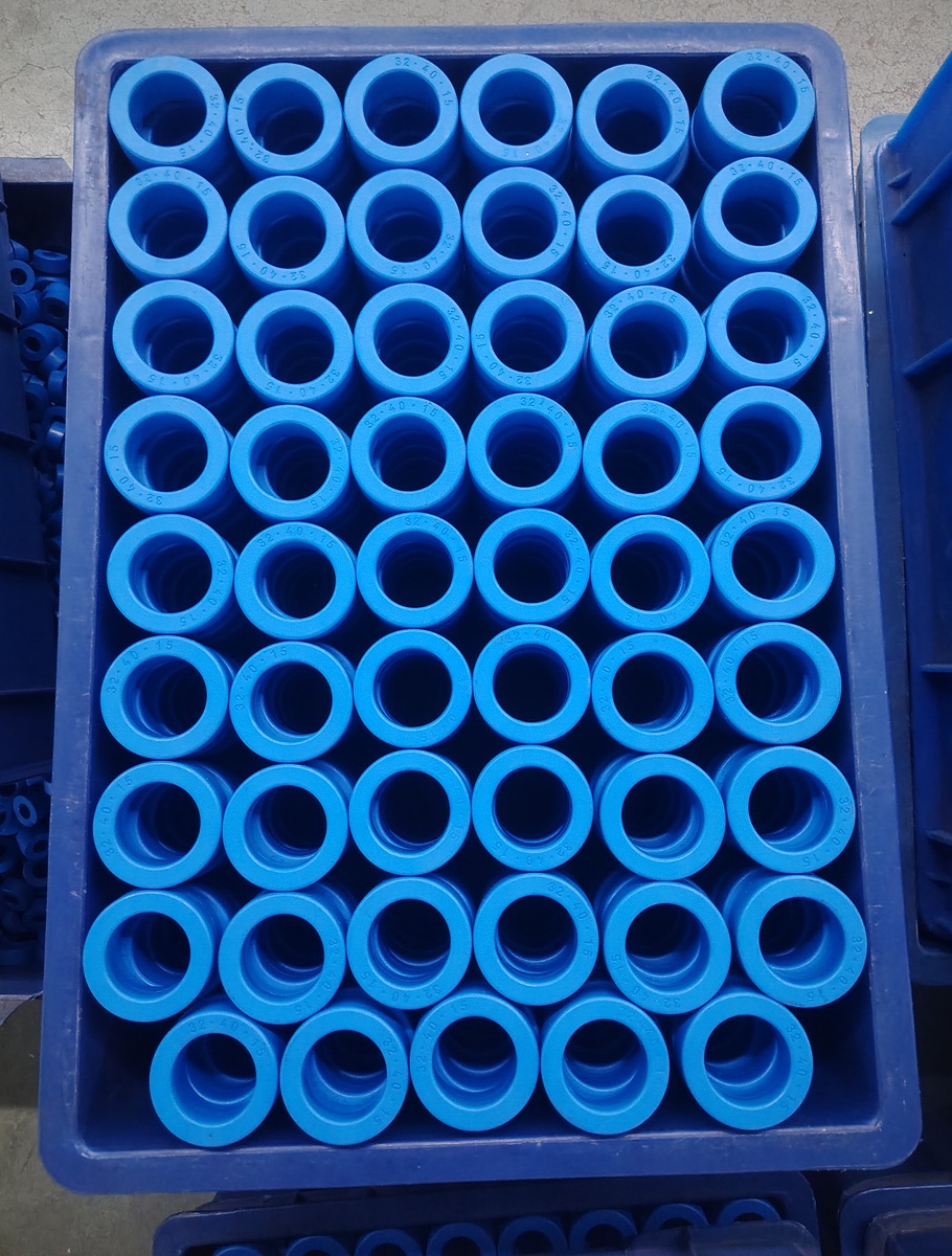 Blue-coated nanocrystalline toroidal cores nested upright in a structured production tray for batch handling